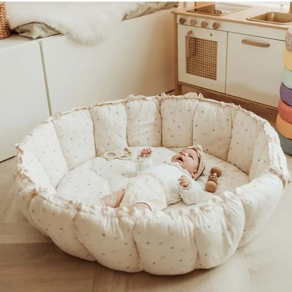PlayandGo_organic_babymat_Bloom_moon_raised_edges_baby_inside_in_kidsroom_with_toy_kitchen.webp